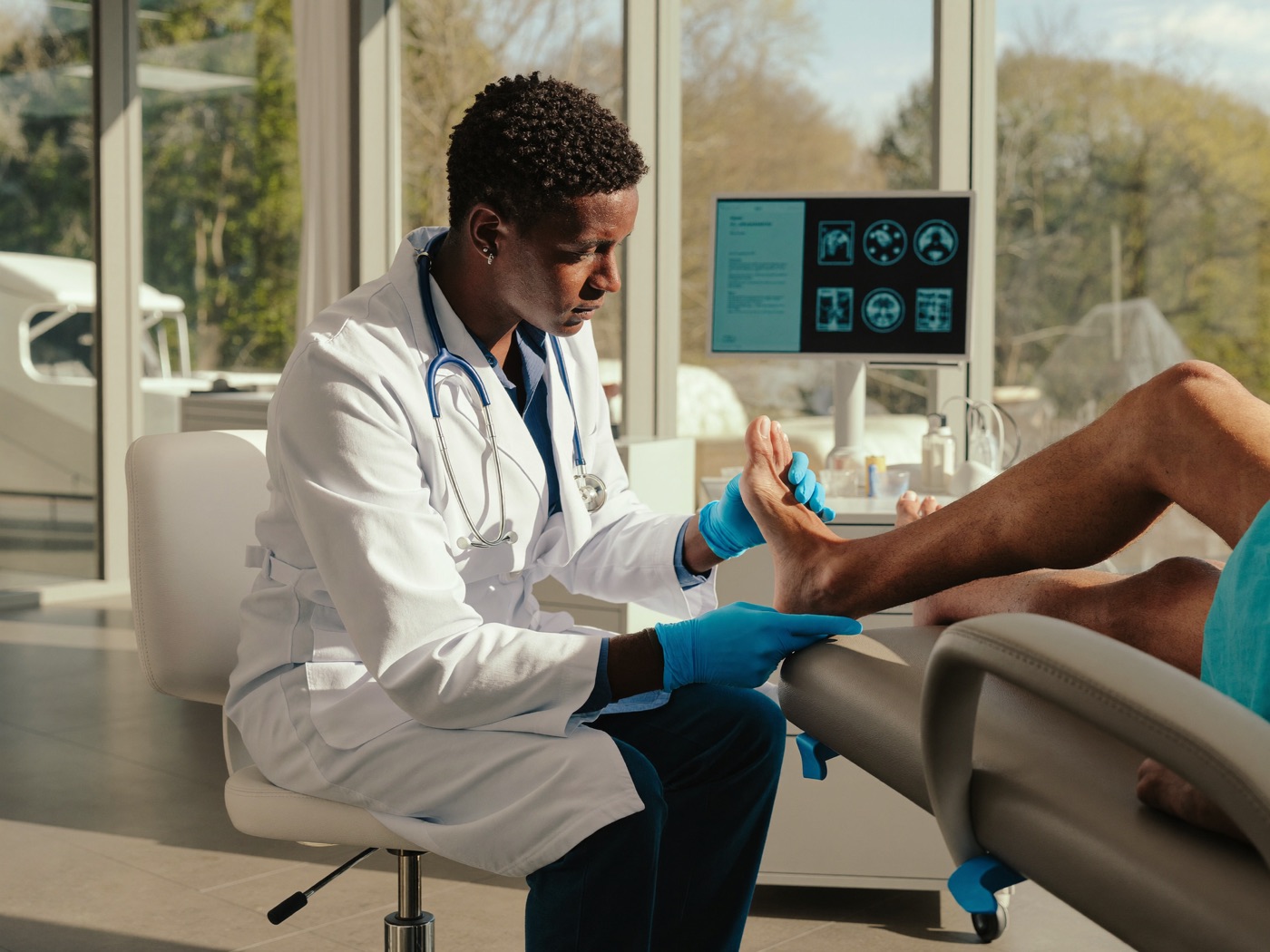 Podiatrist examining a patient's foot and ankle