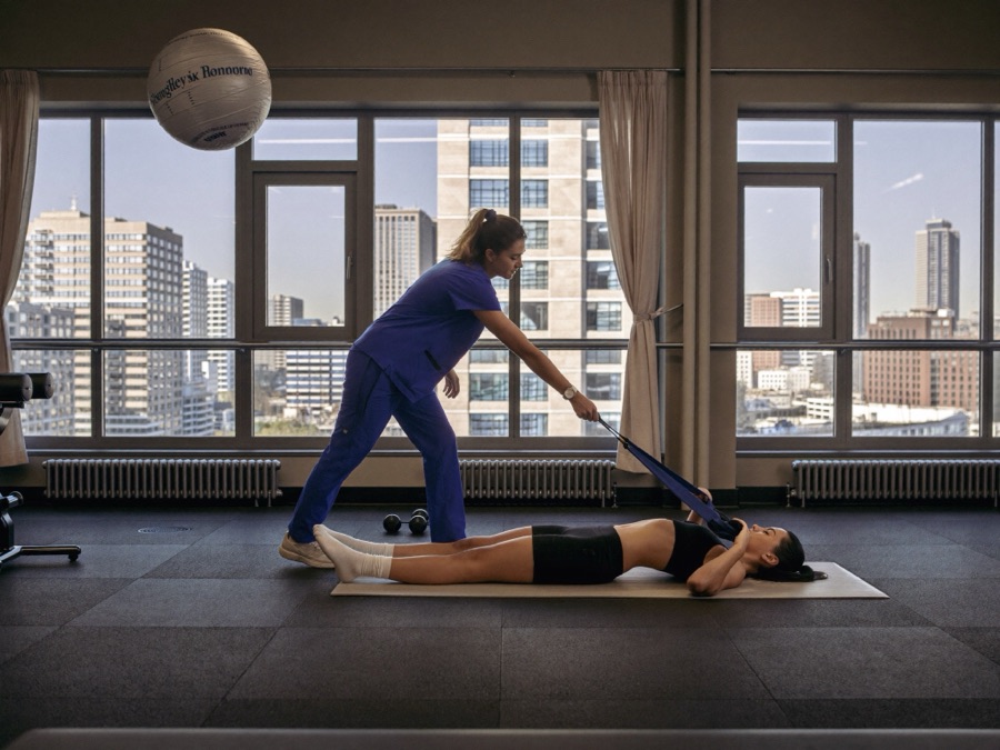 Physiatrist assessing a patient's movement and strength